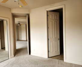 Unfurnished bedroom with carpet floors and a ceiling fan