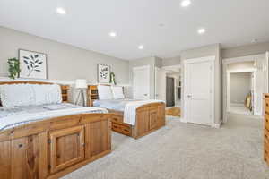 Bedroom with light carpet and recessed lighting
