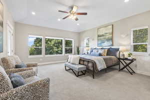 Bedroom with light colored carpet, recessed lighting, and a ceiling fan