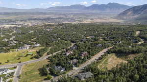 Aerial view of property and surrounding area featuring a mountain backdrop