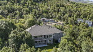 View of subject property featuring a forest and a mountainous background