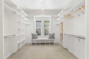 Spacious walk in closet featuring carpet floors