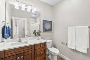 Bathroom featuring vanity, a stall shower, and wood finished floors