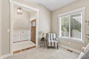 Sitting room featuring carpet floors and baseboards