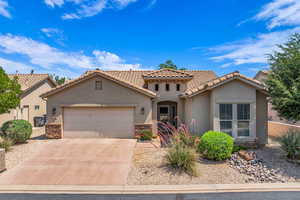 Mediterranean / spanish-style house featuring stone siding, stucco siding, concrete driveway, an attached garage, and a tile roof