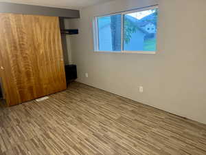 Unfurnished bedroom featuring a closet and wood finished floors