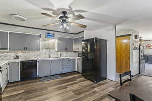 Kitchen featuring black appliances, a ceiling fan, gray cabinets, and dark wood-style flooring