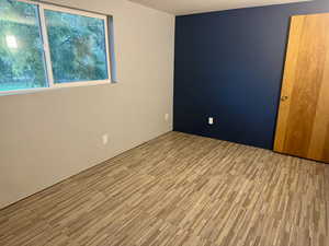 Spare room featuring wood finished floors