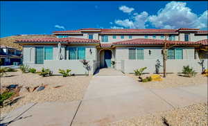 Mediterranean / spanish home featuring stucco siding and a tile roof