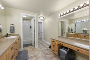 Bathroom with vanity, tub / shower combination, and tile floors