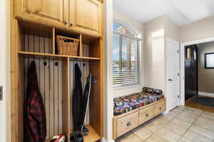 Mudroom featuring healthy amount of natural light and light tile patterned floors