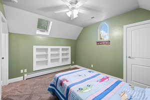 Carpeted bedroom with a baseboard heating unit, vaulted ceiling, ceiling fan, and a textured ceiling