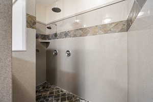 Bathroom featuring a tile shower