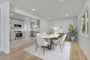 Open Great Room / Dining Area with freshly finished hardwood floors, recessed lighting, and healthy amount of natural light.