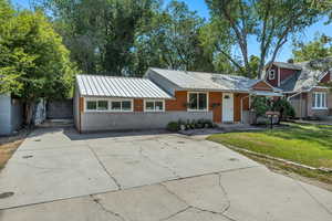 Remodeled 1 Level Living featuring 3 bedrooms / 2 baths with concrete driveway, a metal roof, and a fenced back yard and open space park like front lawn.