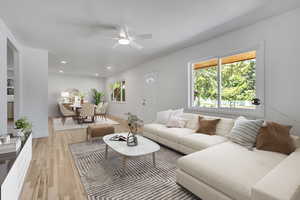Open Great Room / Living room featuring freshly finished hard wood-floors, ceiling fan and recessed lighting.
