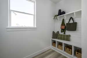 Mudroom featuring wood finished floors and baseboards