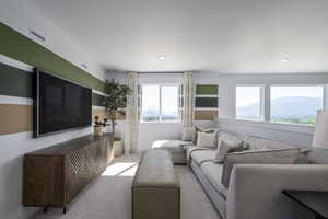 Carpeted living area with recessed lighting and a mountain view