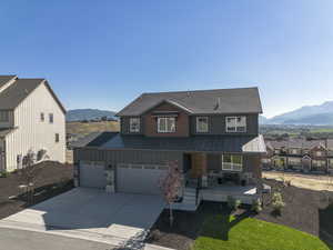 View of front of property featuring a porch, a mountain view, board and batten siding, and a standing seam roof