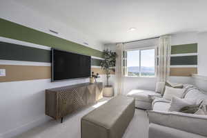 Carpeted living area featuring baseboards