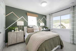 Bedroom with light colored carpet and baseboards