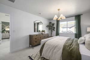 Bedroom featuring light carpet and a chandelier