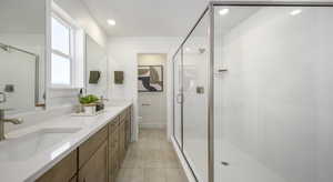 Full bath with double vanity, a stall shower, tile patterned flooring, and recessed lighting