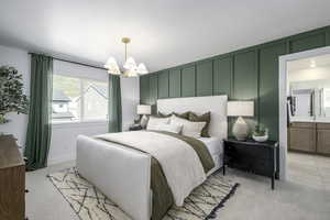 Bedroom with light carpet, a chandelier, a decorative wall, and ensuite bathroom