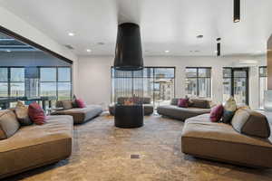Carpeted living room featuring recessed lighting