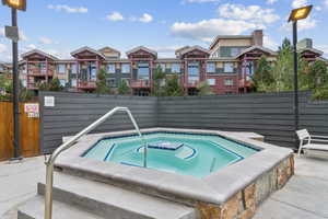 View of pool featuring a hot tub
