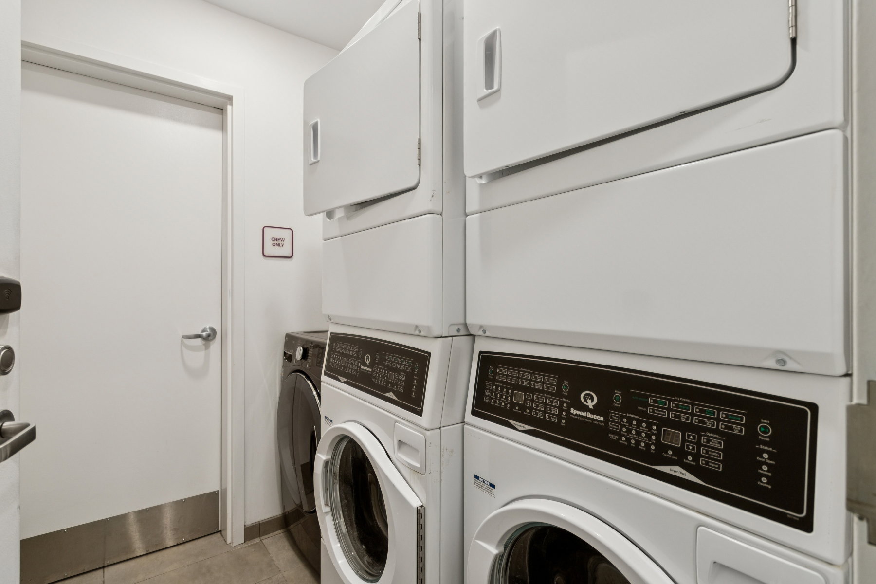 Washroom featuring washing machine and clothes dryer and light tile patterned floors