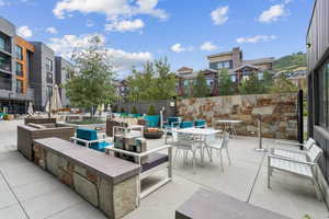 View of patio featuring a residential view and an outdoor living space with a fire pit