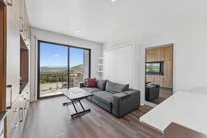 Living area with wood finished floors and recessed lighting