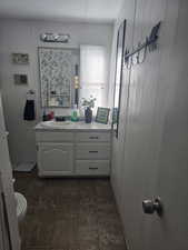 Bathroom with vanity and wood walls