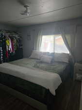Bedroom featuring dark wood-style floors and a closet