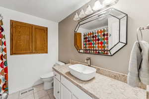 Full bath featuring vanity, tile patterned floors, a textured ceiling, and a shower with shower curtain