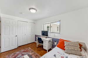 Bedroom featuring a textured ceiling and a closet