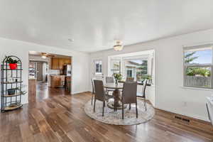 Dining room featuring dark wood-style flooring