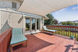 Wooden deck with a fenced backyard