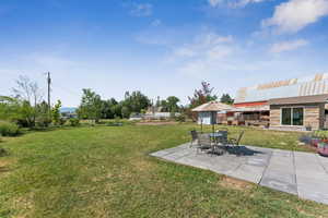 View of green lawn with a patio