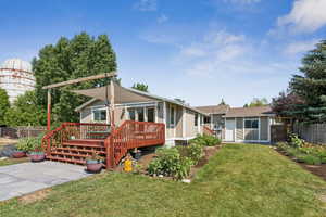 Rear view of house with a wooden deck
