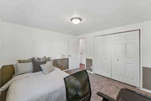 Carpeted bedroom with a closet and baseboards