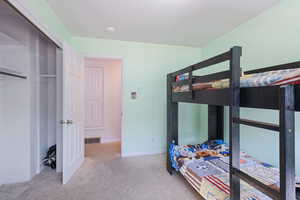 Carpeted bedroom featuring baseboards
