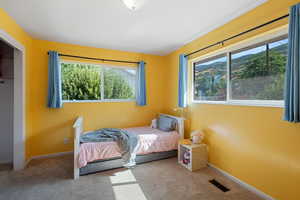 Carpeted bedroom with baseboards