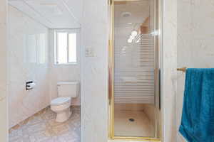 Full bath featuring a stall shower and a textured ceiling