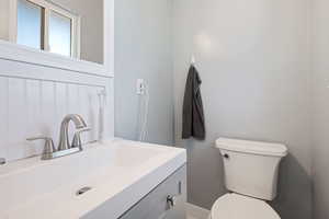 Half bathroom with vanity and toilet