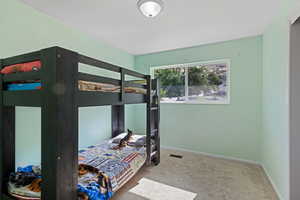 Bedroom with carpet and baseboards