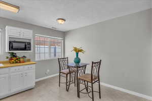 Dining room featuring a textured ceiling and light flooring
