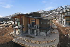 View of front of home featuring a mountain view and stone siding