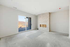 Unfurnished living room featuring unfinished concrete floors